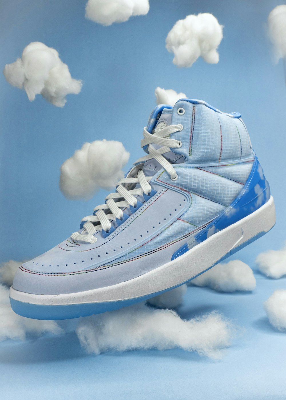 a blue shoe with white clouds