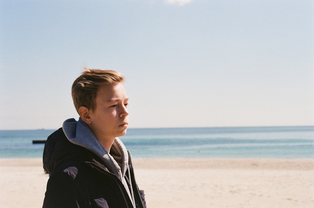 a man standing on top of a sandy beach