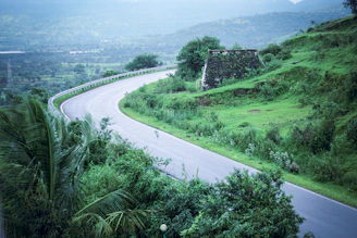 A winding road through verdant hills leading to the peaceful villas near Kainchi Dham.