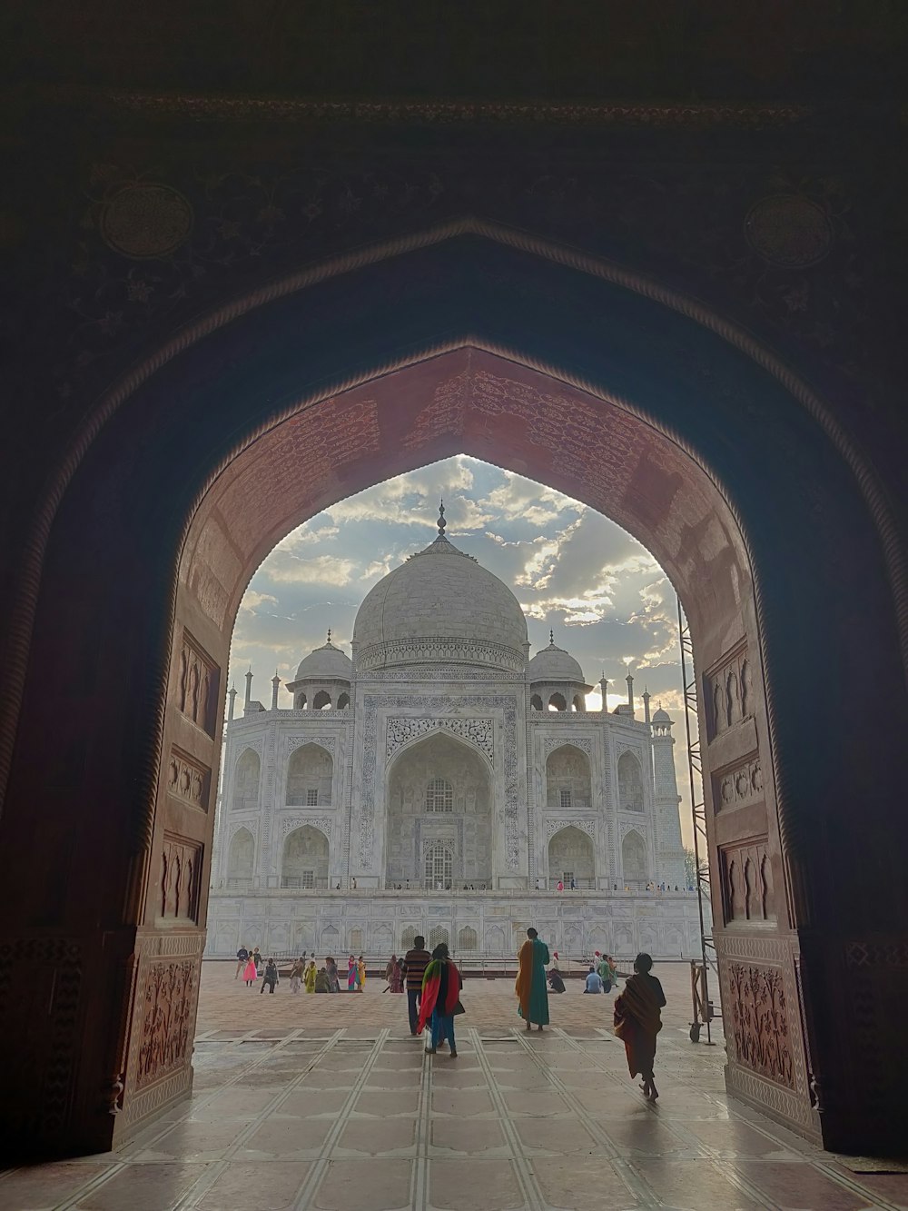 a large arched doorway with people walking around