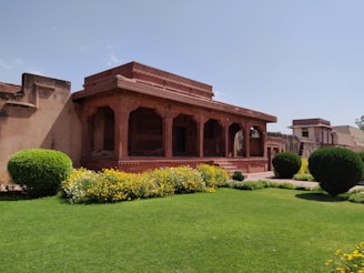 a large building with a lawn in front of it