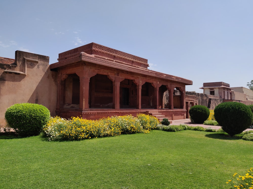 a large building with a lawn in front of it