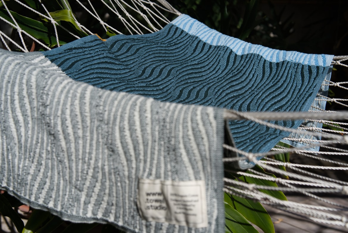 Origami River knitted towel in Rainy Blue. Made in Berlin by Towel.Studio, this towel features alternating patterns of terry and standard knitted stitches.