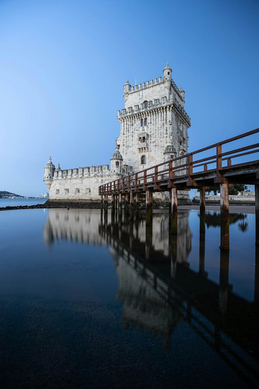 a bridge over water with a building on the other side