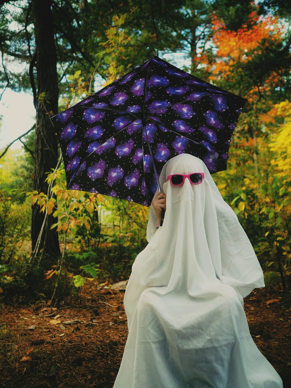 a person wearing a white dress and holding an umbrella