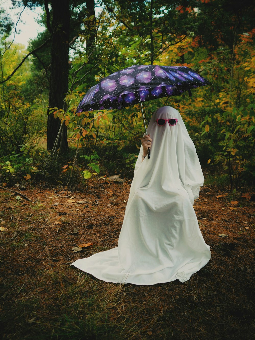 a person in a white dress holding an umbrella