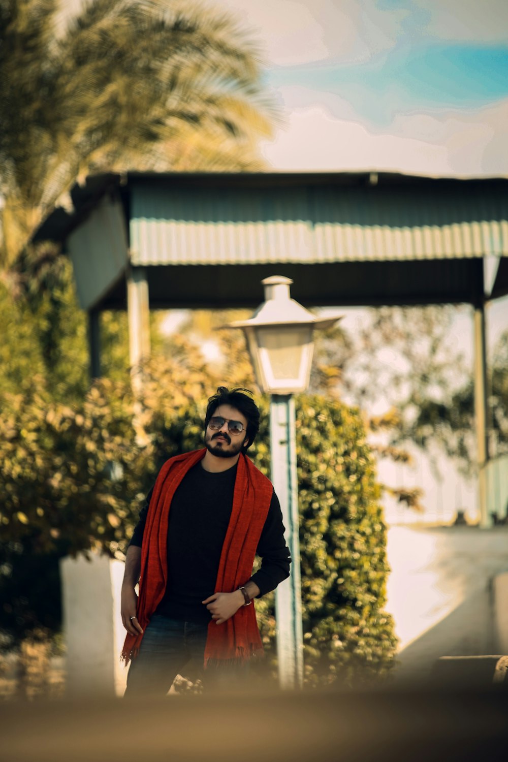 a person wearing a red robe and standing outside a building