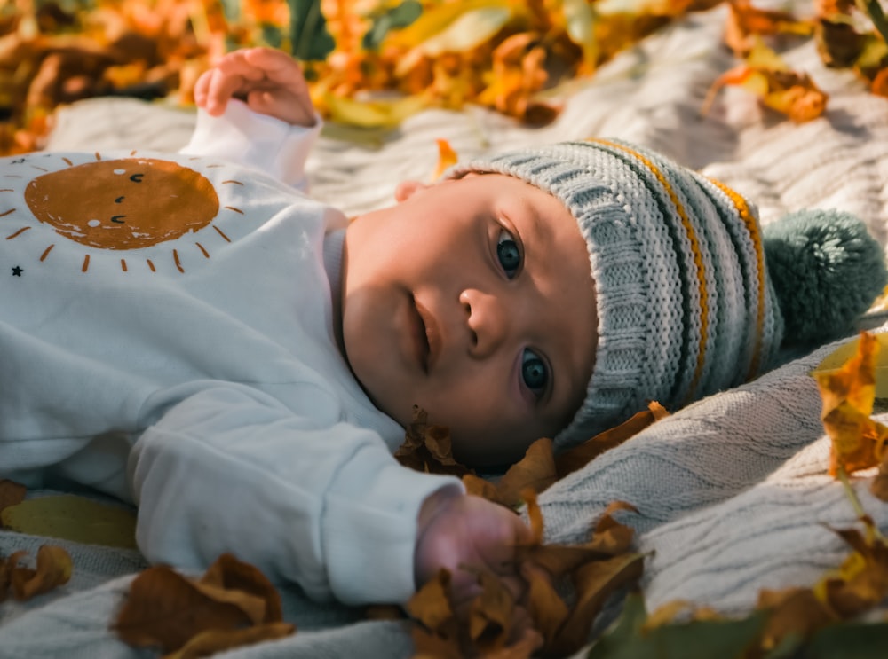 a baby lying on a blanket