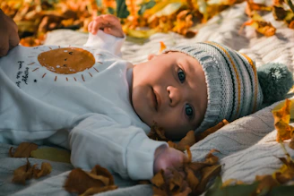 a baby lying on a blanket