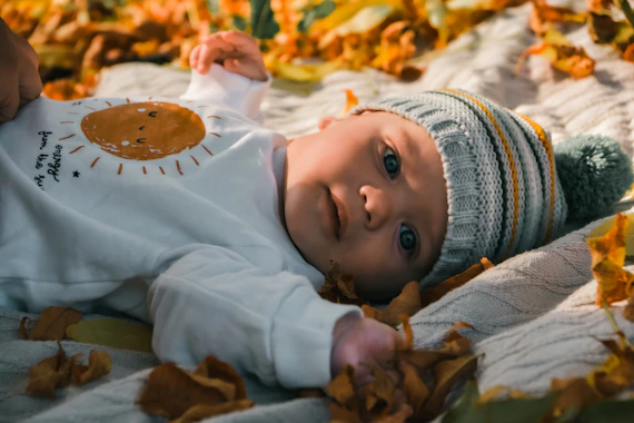 a baby lying on a blanket