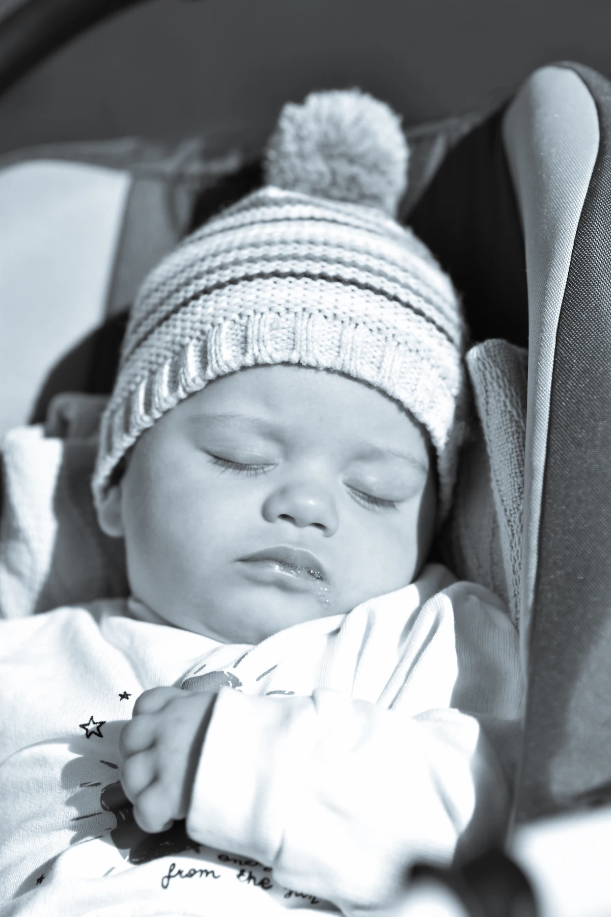 Baby sleeping in a car seat during a road trip