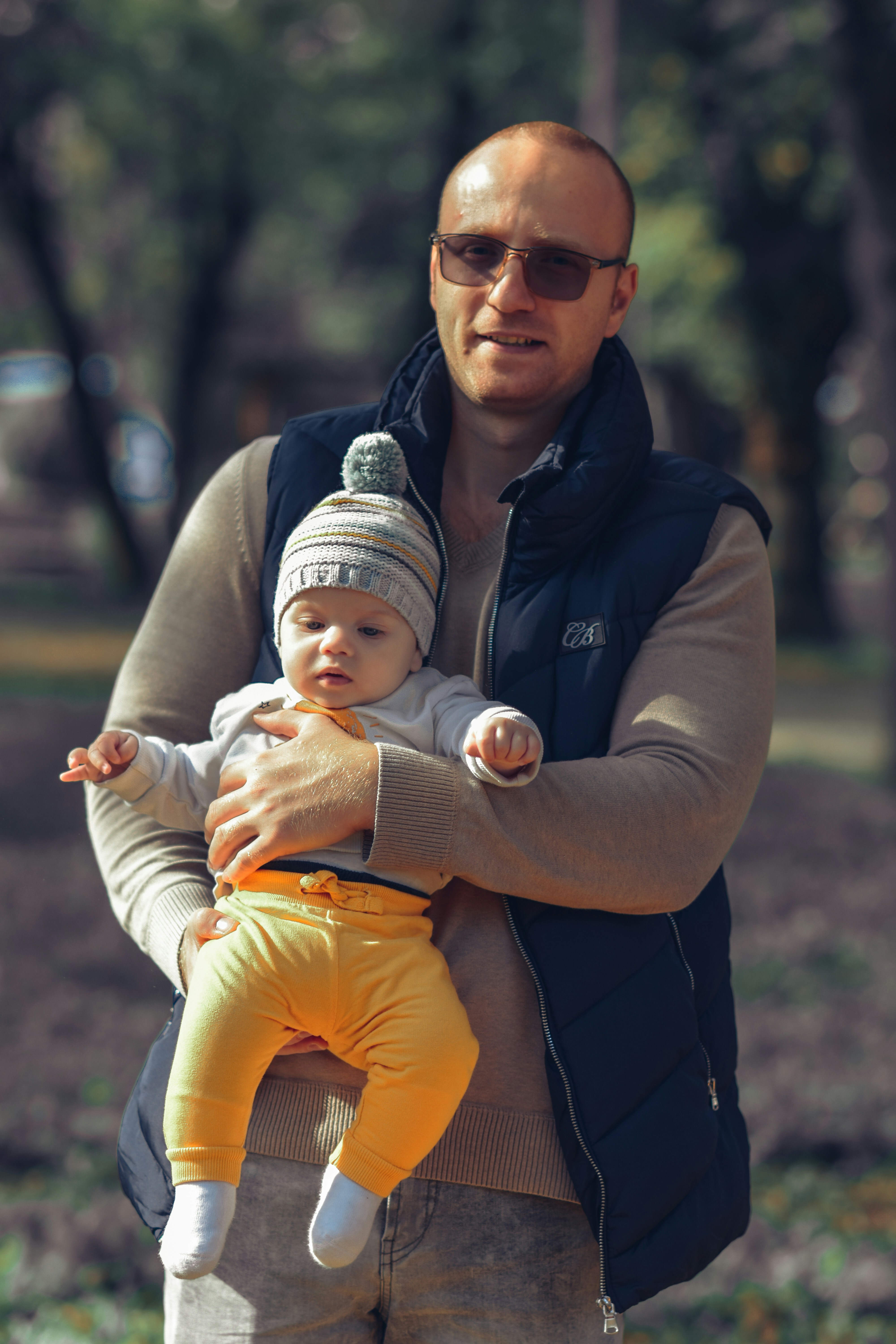 Young father confidently holding his baby