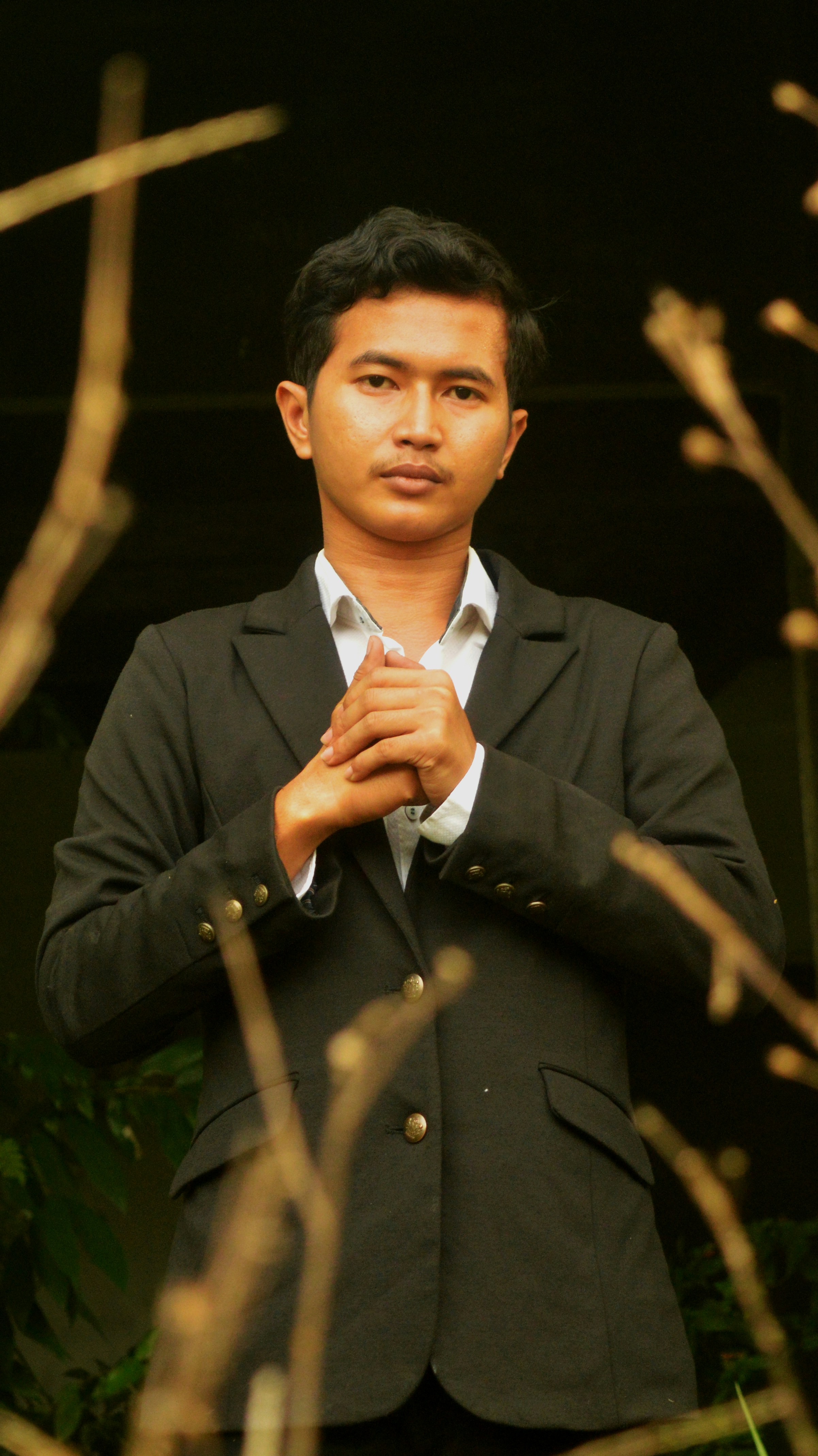 a man in a suit holding a microphone