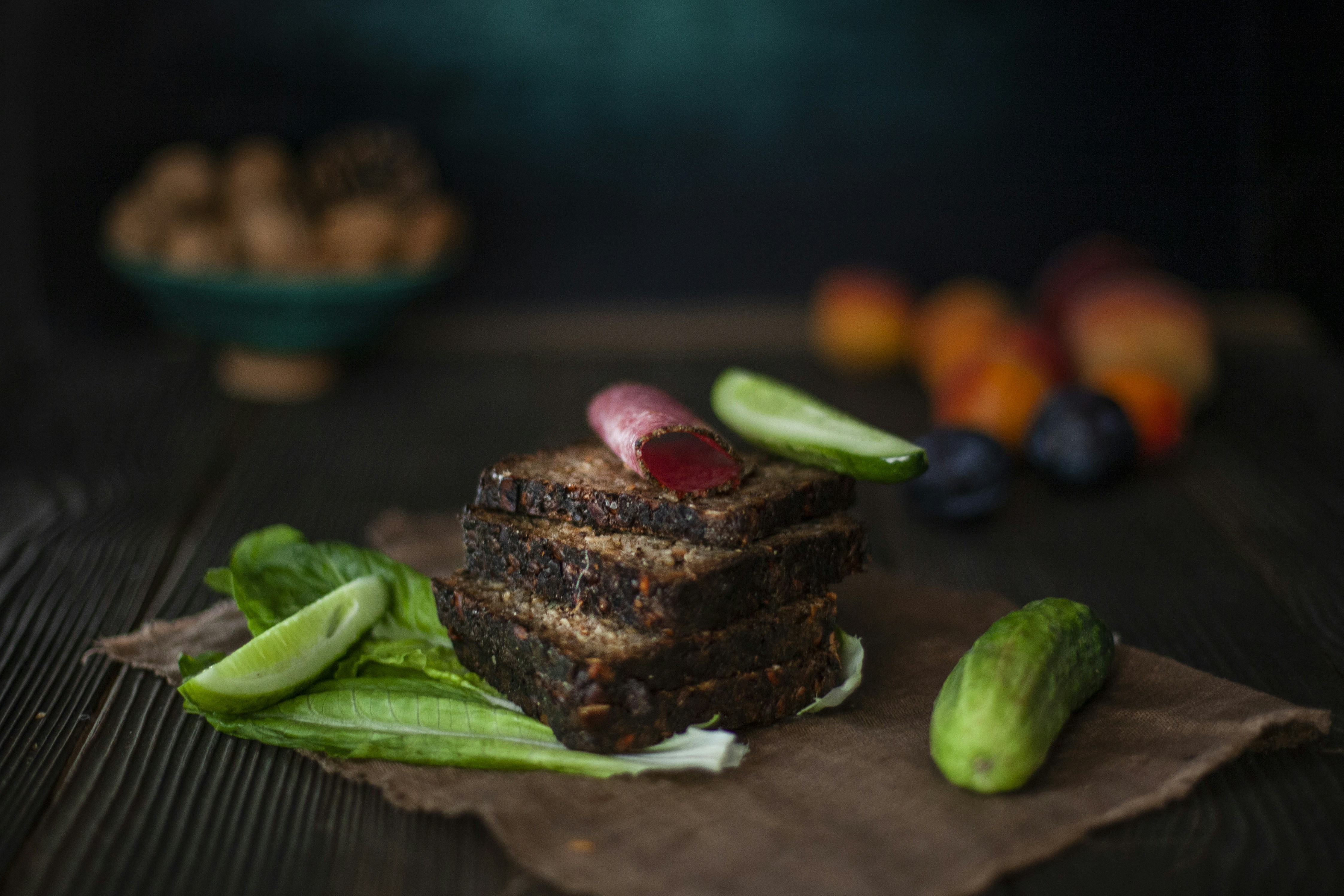 a piece of chocolate cake with fruit on a wooden surface