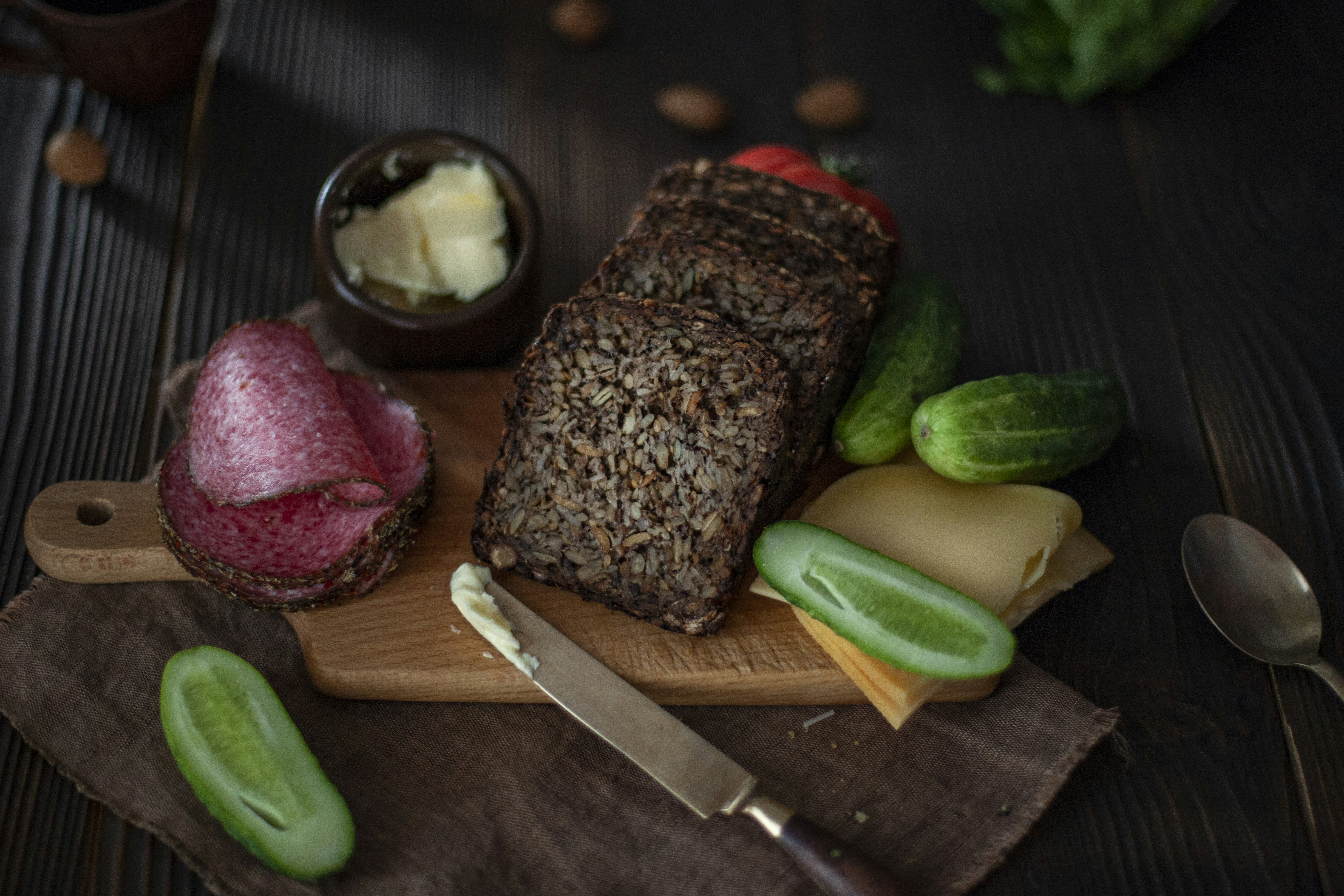 a wooden cutting board with meat and vegetables on it