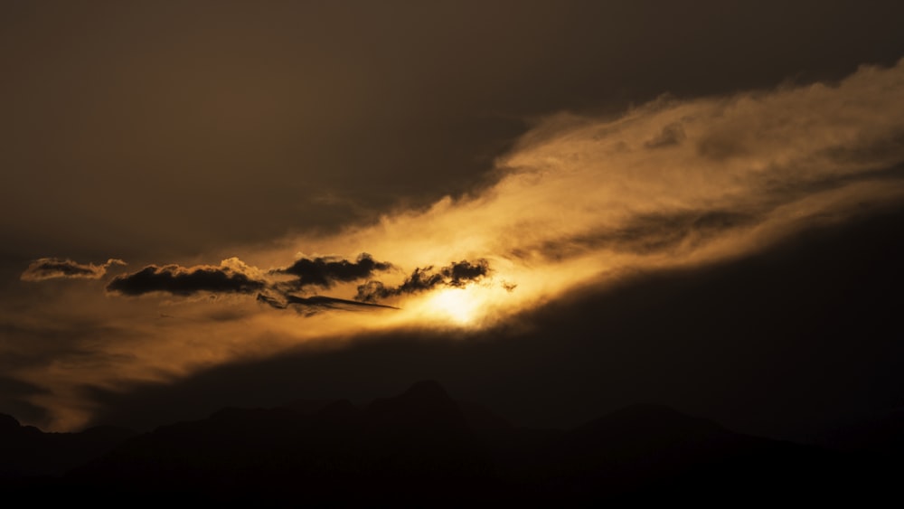 a sunset over a mountain