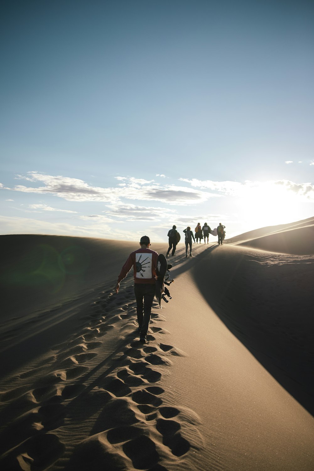 a group of people walking on a path in a desert