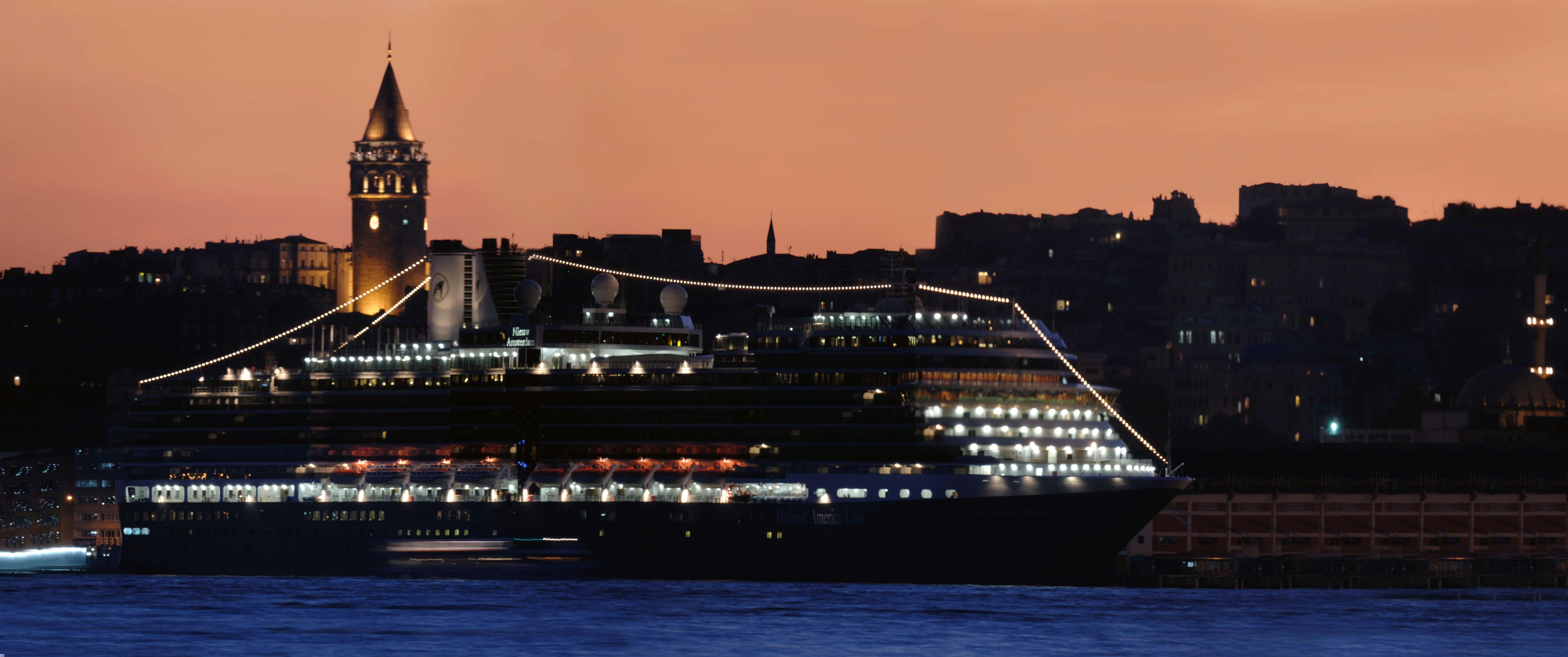 a bridge over water with a tower in the background