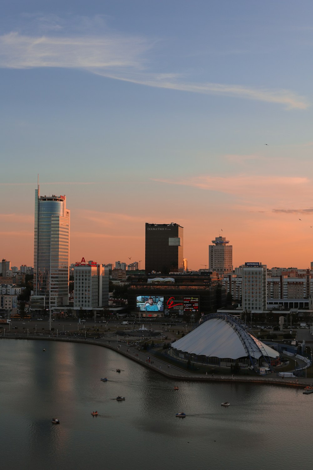 a city skyline with a body of water in the foreground