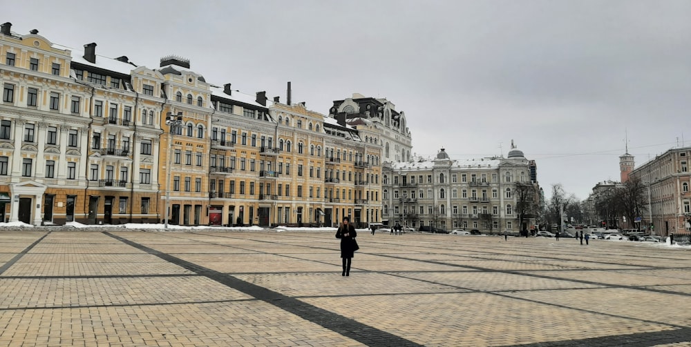 a person walking on a street with buildings on either side of it