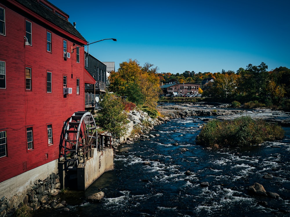 a river with a bridge and buildings