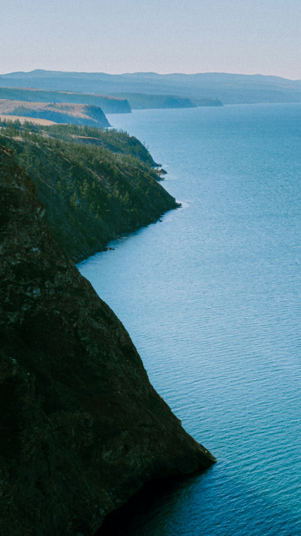 a cliff with a body of water below