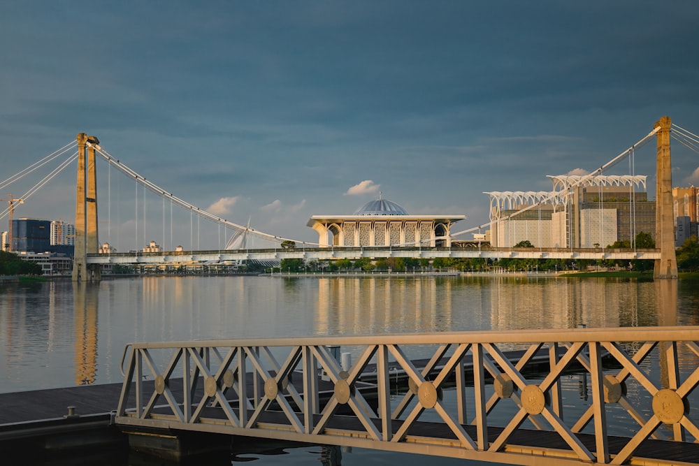 a bridge over water with a building in the background