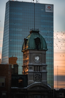 a clock tower in front of a building
