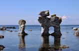 a group of large rocks in the water