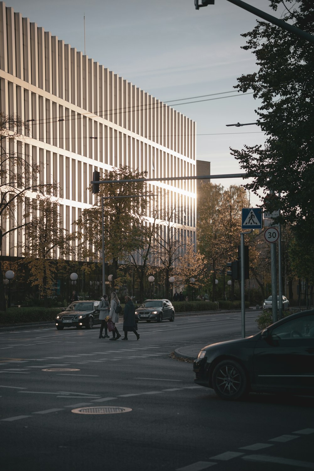 a street with cars and people walking on it