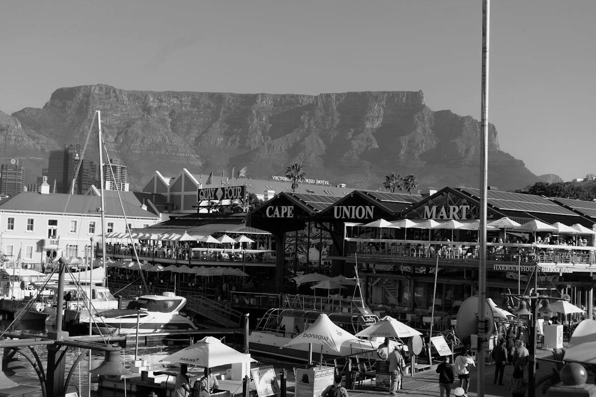 Visitors walking beside the harbour at the V&A Waterfront in Cape Town