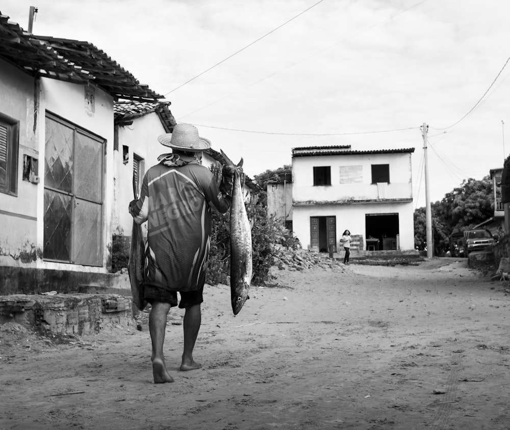 a man walking down a dirt road