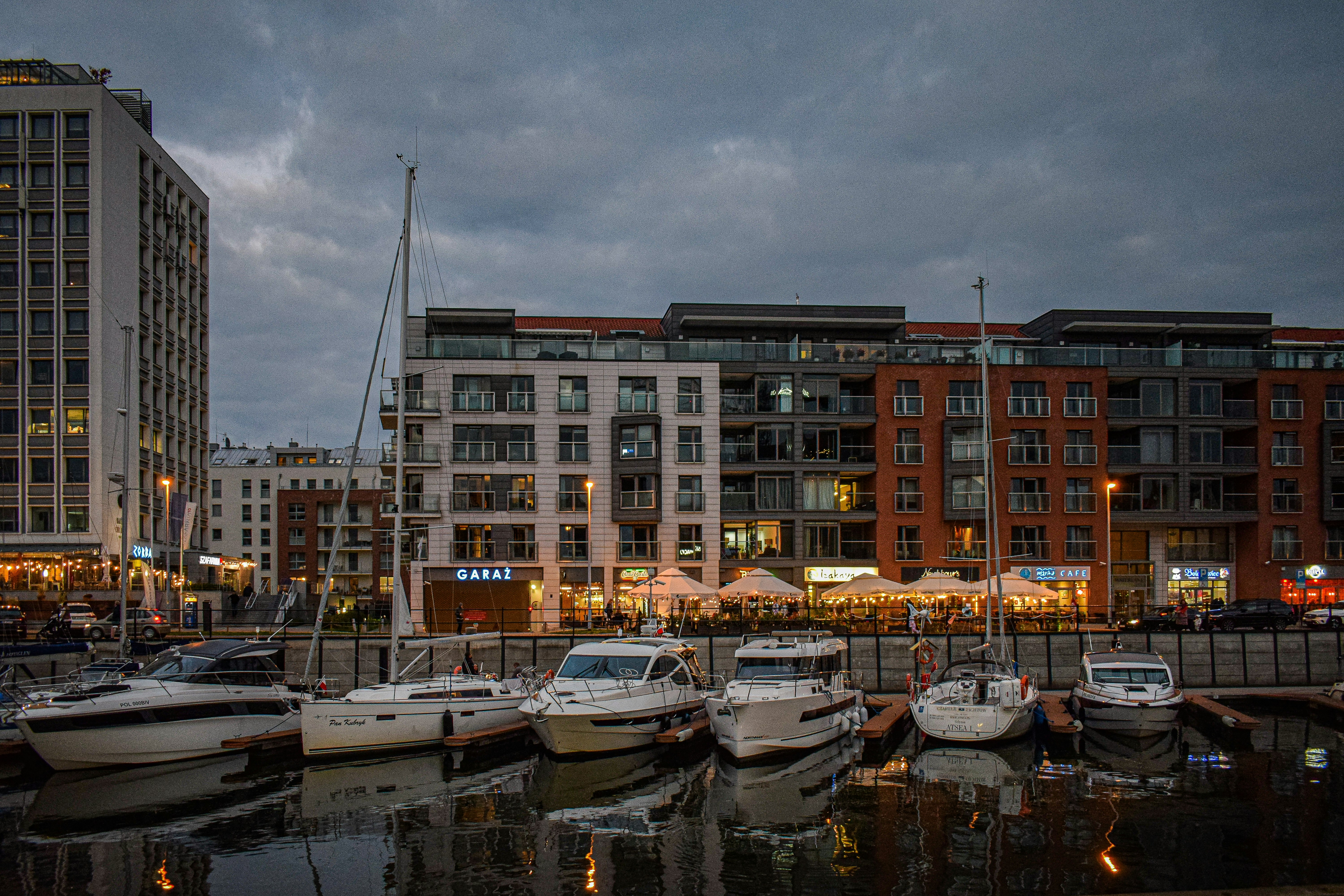 a group of boats sit in a harbor