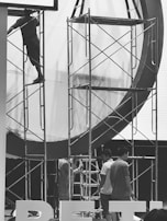 Team of workers safely dismantling a large industrial structure.