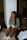 a woman sitting on the floor talking on a cell phone