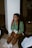 a woman sitting on the floor talking on a cell phone