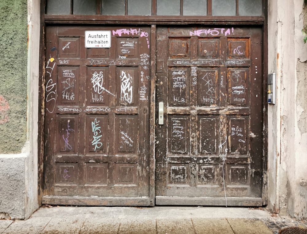 a wooden door with graffiti on it