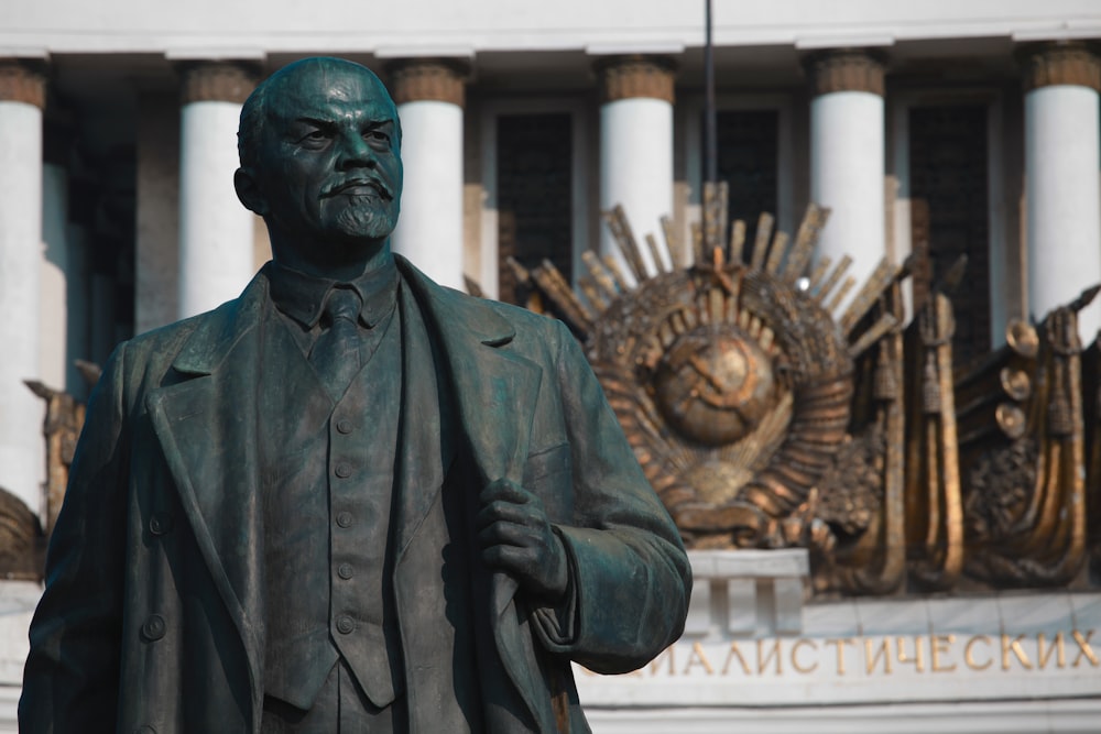 a statue of a man holding a book