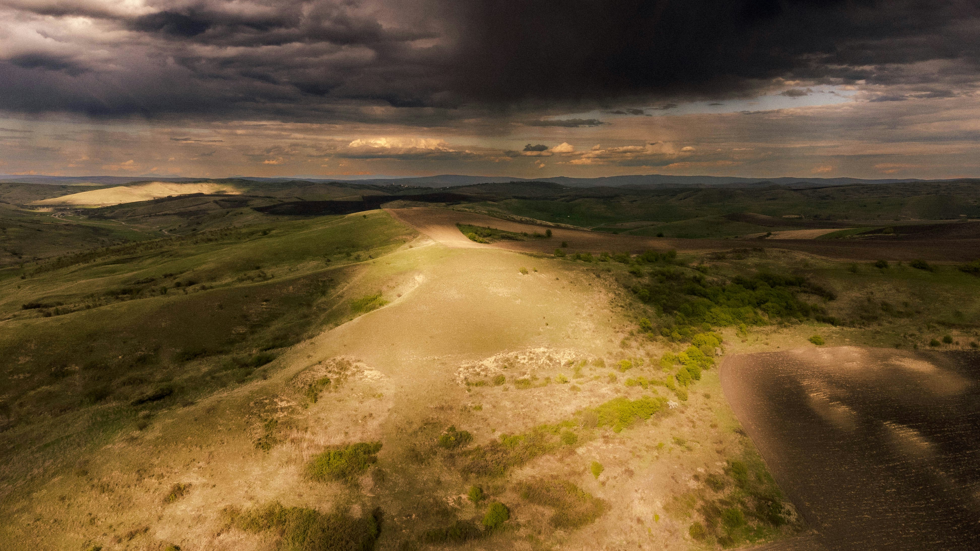 a dirt road in a field
