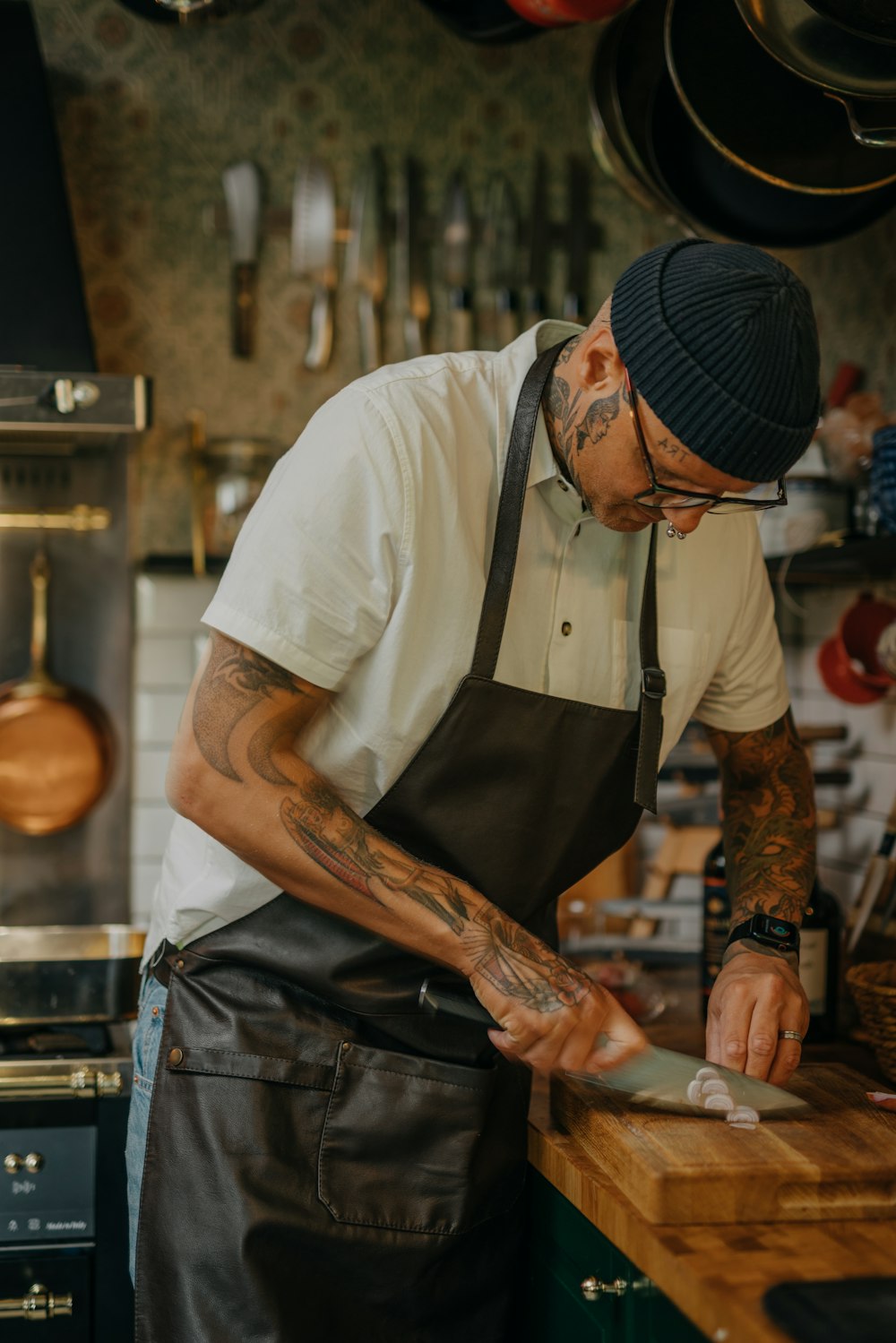 a man with tattoos holding a knife