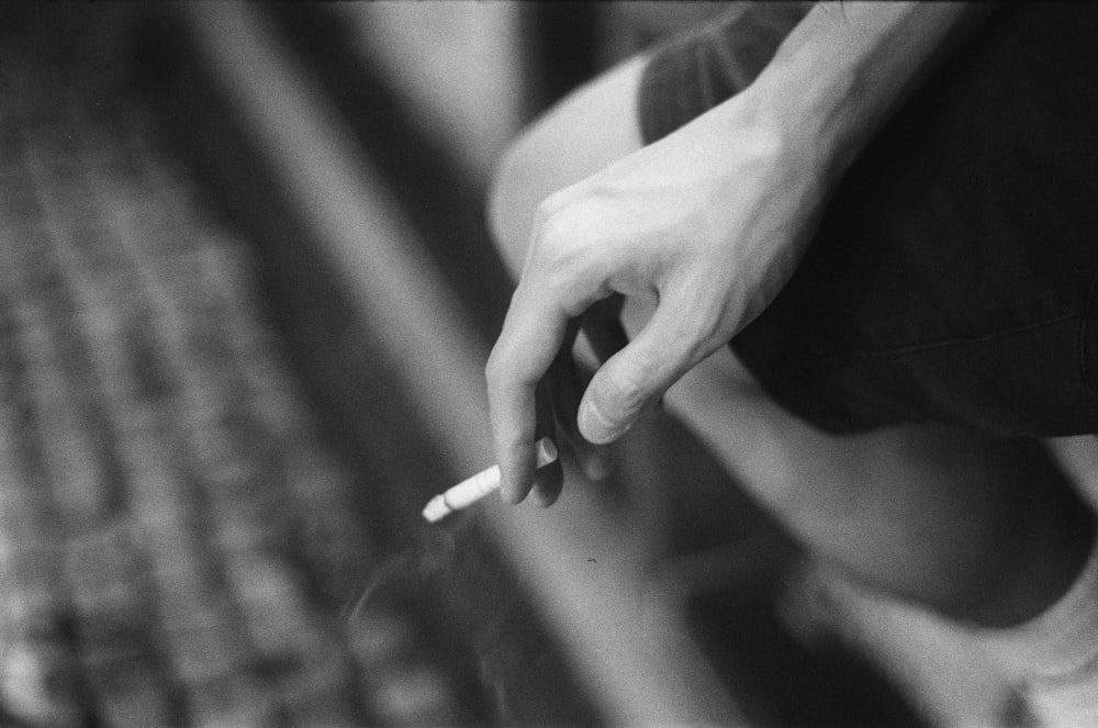 a person holding a cigarette