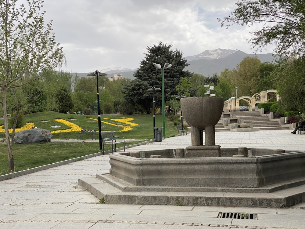 a stone statue in a park