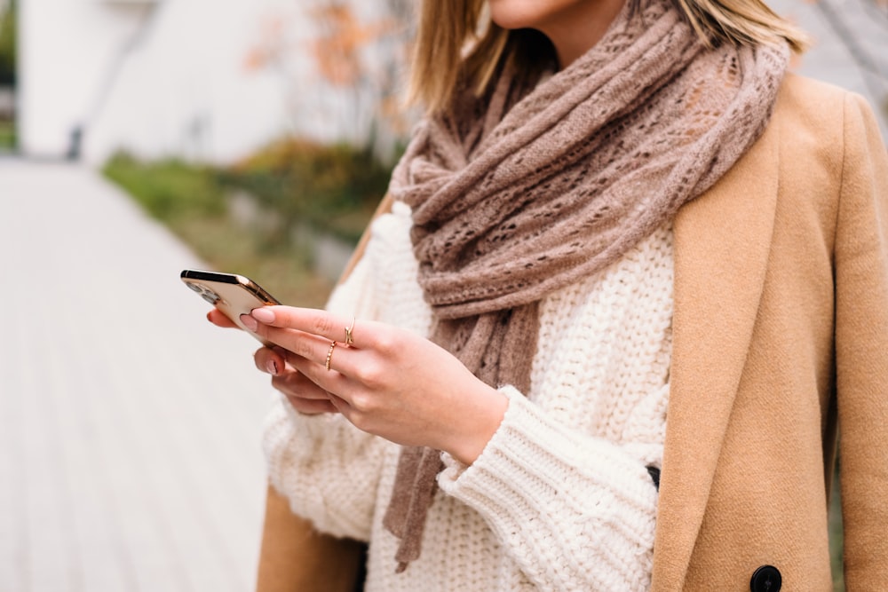 a woman holding a phone