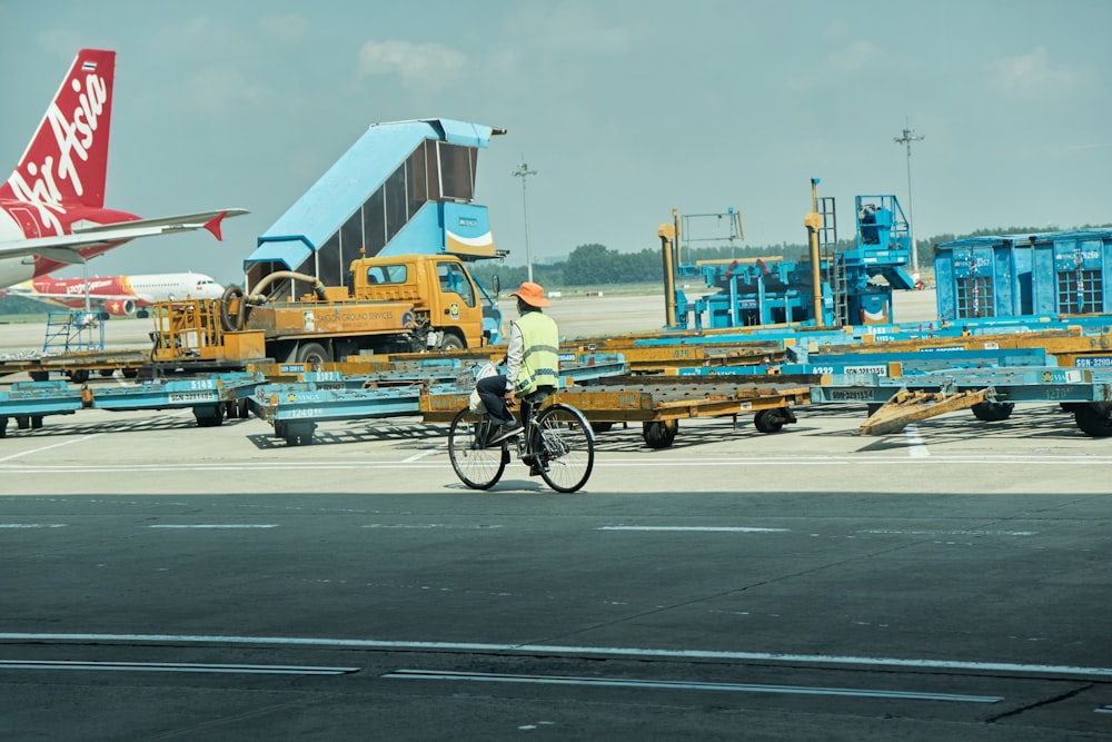 a person riding a bicycle on a runway