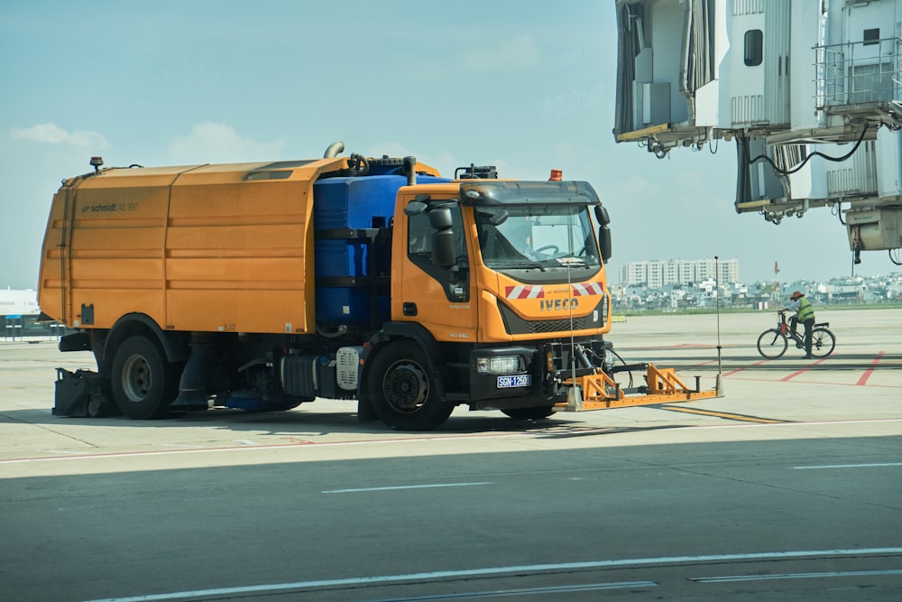 a large orange truck on the street