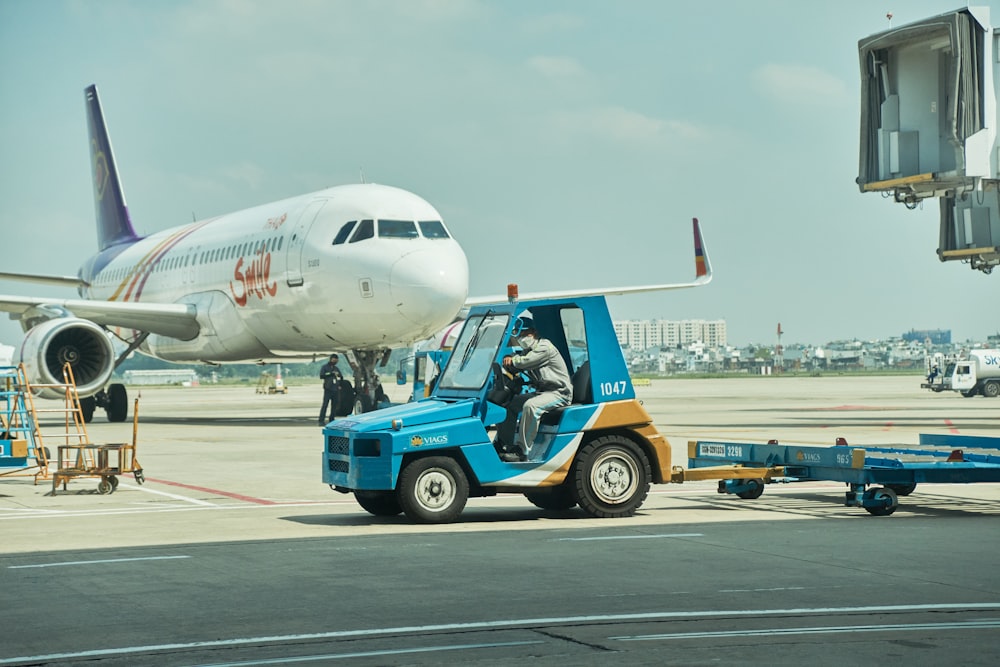 a person on a forklift pulling a plane