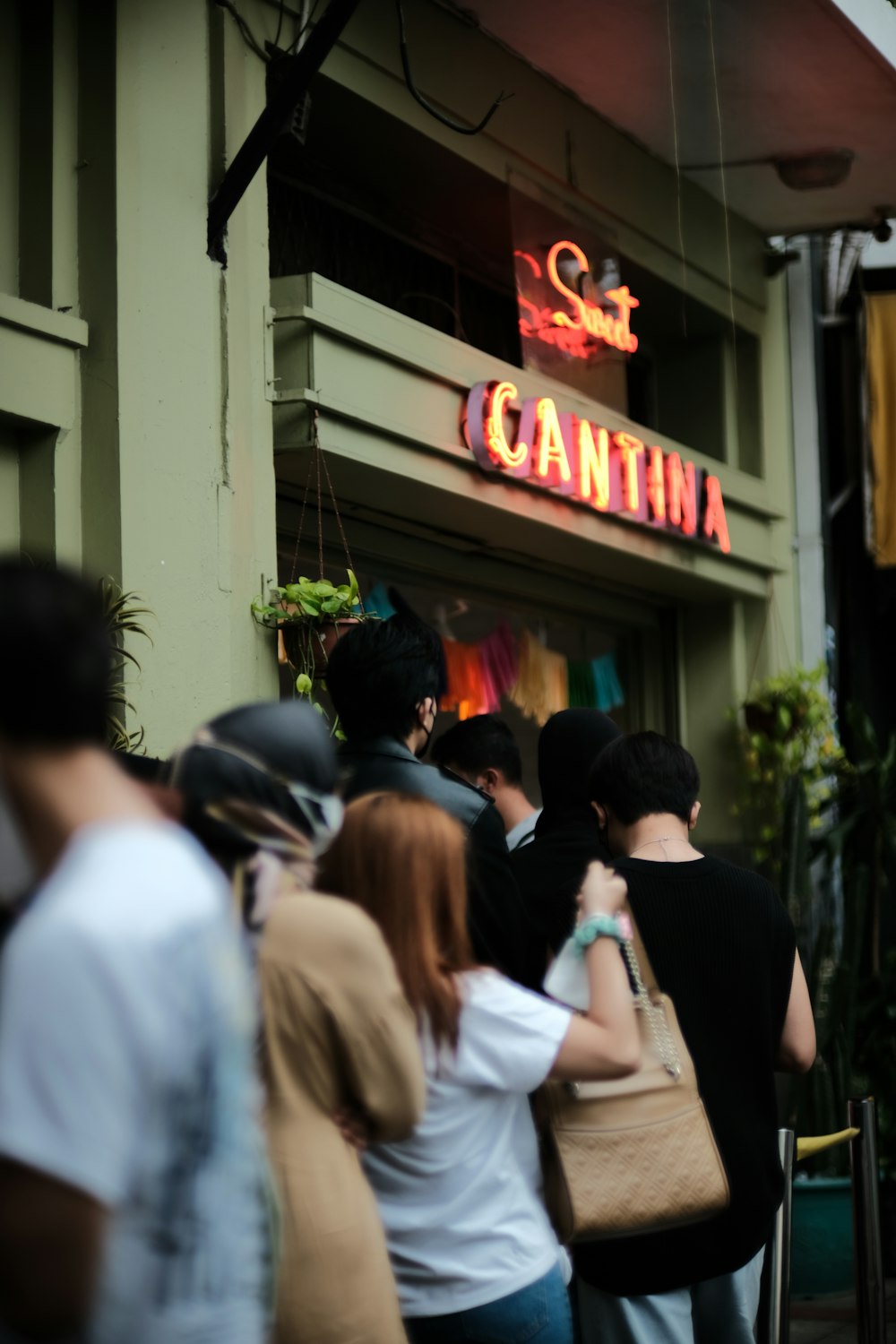 a group of people walking outside a restaurant