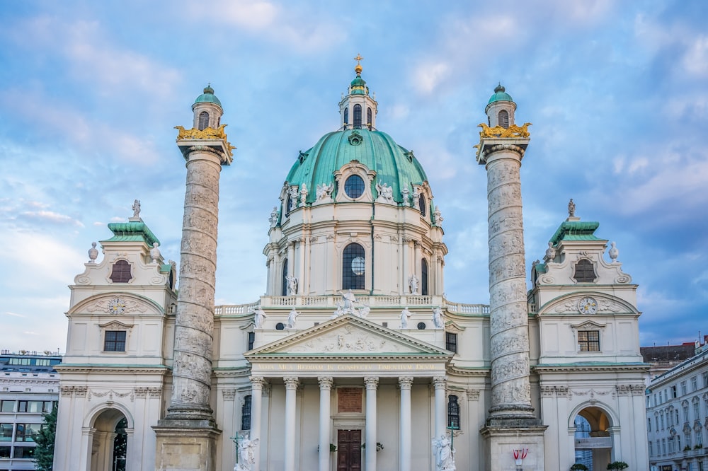 a large white building with towers with Karlskirche in the background