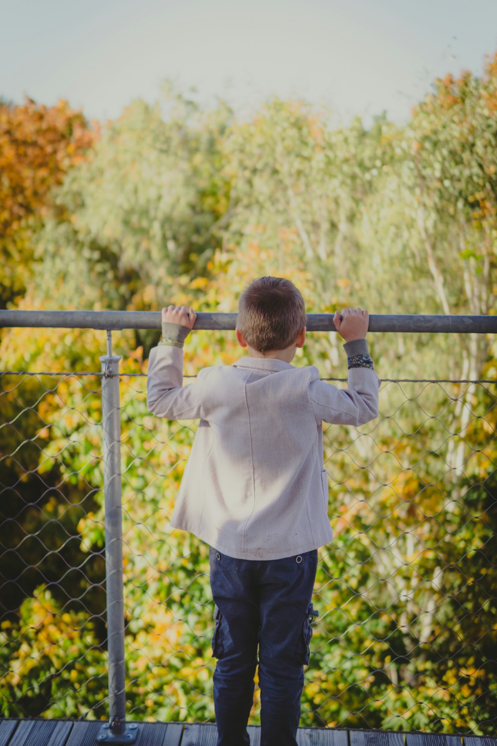 a boy climbing a metal railing