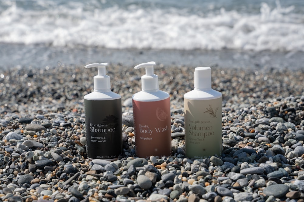 a group of bottles on a rocky beach